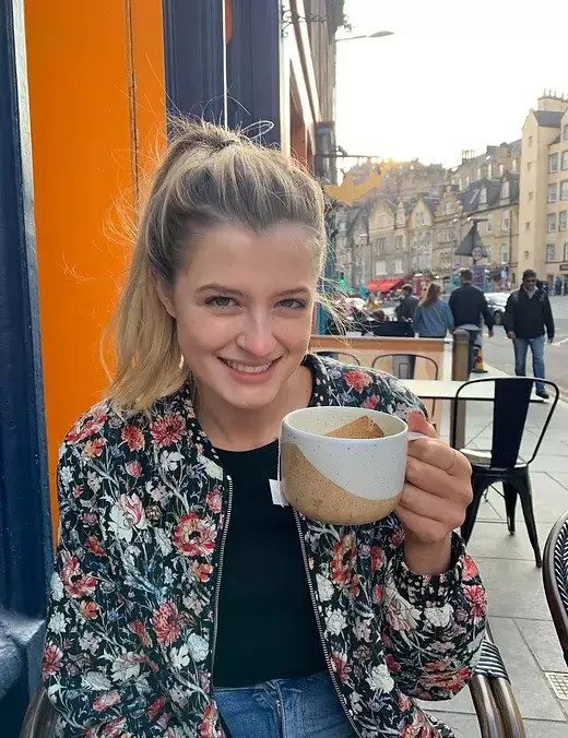 Freya Mallard Comedian holding a Coffee Cup