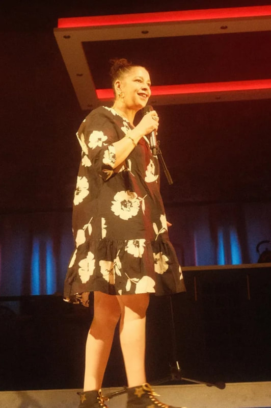 Josephine Lacey Comedian Holding A Mic 